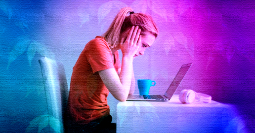 A sorrowful woman in front of a laptop